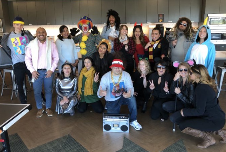 staff group photo in halloween costumes