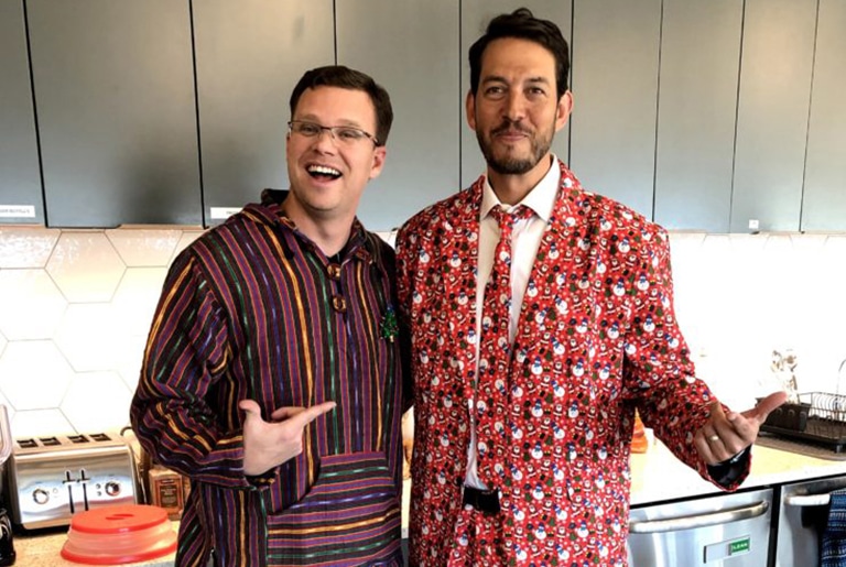 two employees dressed for Christmas holiday party